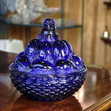 Westmoreland cobalt blue hen laying eggs on basket nest